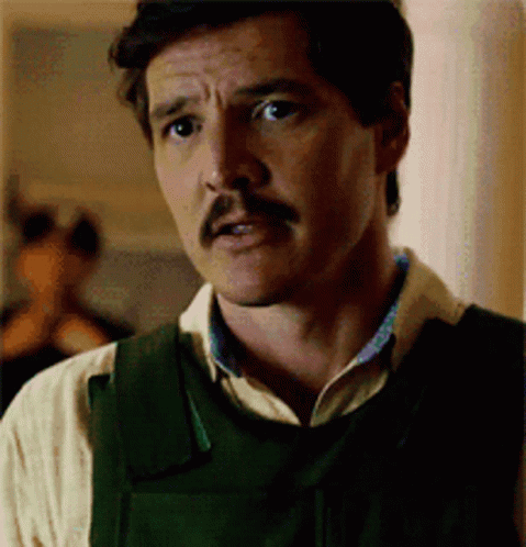 A Man With A Mustache Is Wearing A Vest And A White Shirt . GIF