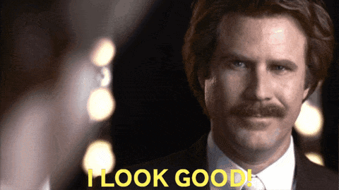 A Man With A Mustache Says " I Look Good " In Yellow Letters GIF