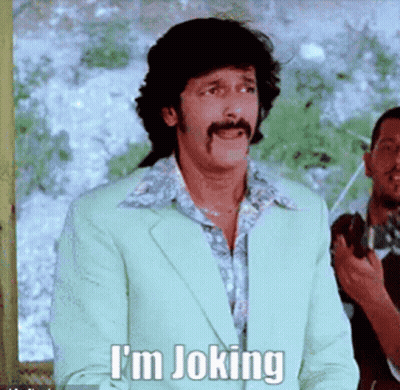 A Man With A Mustache Says I 'M Joking In A Green Suit GIF