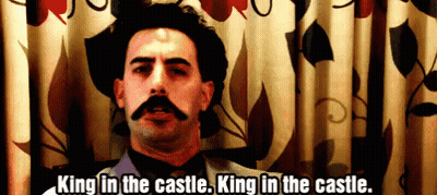 A Man With A Mustache Says " King In The Castle " GIF