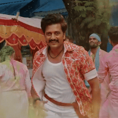 A Man With A Mustache Wearing A Floral Shirt And White Tank Top GIF