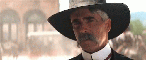 A Man With A Mustache Wearing A Hat And Tie GIF
