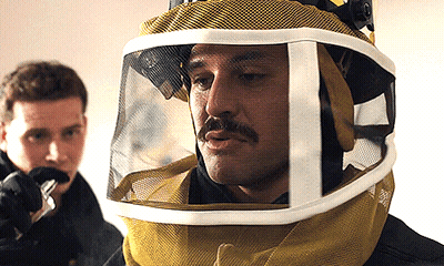 A Man With A Mustache Wearing A Helmet With A Visor GIF