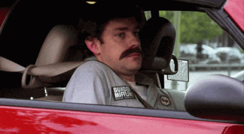 A Man With A Mustache Wearing A Shirt That Says Dunkin Donuts GIF