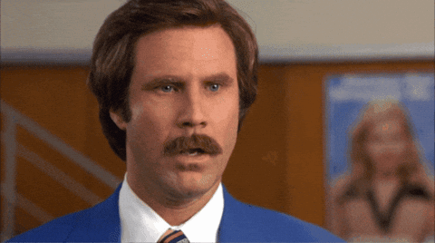 A Man With A Mustache Wearing A Suit And Tie GIF
