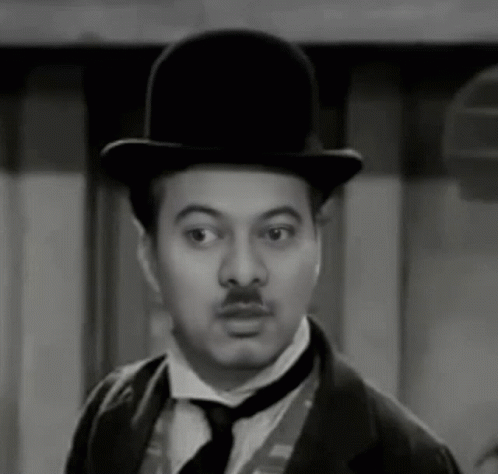 A Man With A Mustache Wearing A Top Hat And Tie GIF