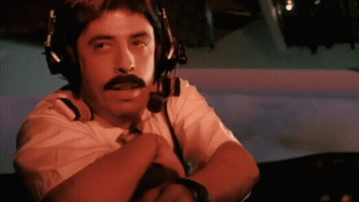 A Man With A Mustache Wearing Headphones And A Microphone GIF