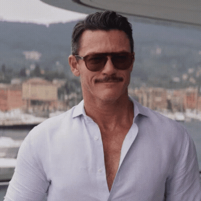 A Man With A Mustache Wearing Sunglasses And A White Shirt GIF