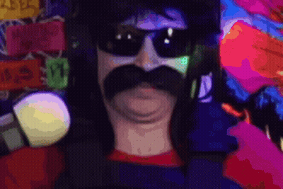 A Man With A Mustache Wearing Sunglasses And Holding A Microphone GIF