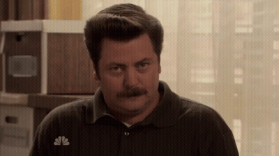 A Man With A Mustache Wears A Nbc Logo On His Shirt GIF