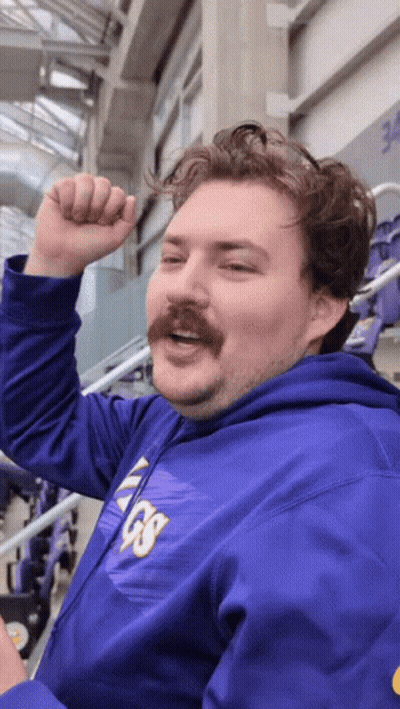 A Man With A Mustache Wears A Purple Vikings Hoodie GIF