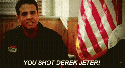 A Man With A Name Tag That Says Jimmy Is Sitting In Front Of An American Flag . GIF