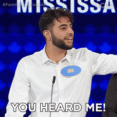 A Man With A Name Tag That Says Mo Stands In Front Of A Microphone And Says " You Heard Me " GIF