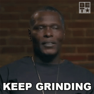 A Man With A Necklace Is Making A Funny Face And Saying `` Keep Grinding '' . GIF
