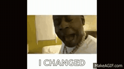 A Man With A Necklace On His Neck Is Sitting On A Bed And Saying `` I Changed '' . GIF
