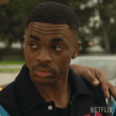 A Man With A Netflix Logo On His Shirt GIF