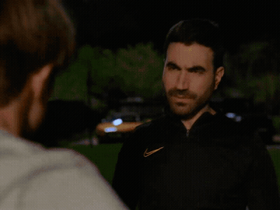 A Man With A Nike Logo On His Jacket Is Looking At Another Man GIF