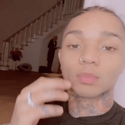 A Man With A Nose Ring And A Tattoo On His Neck Is Taking A Selfie . GIF