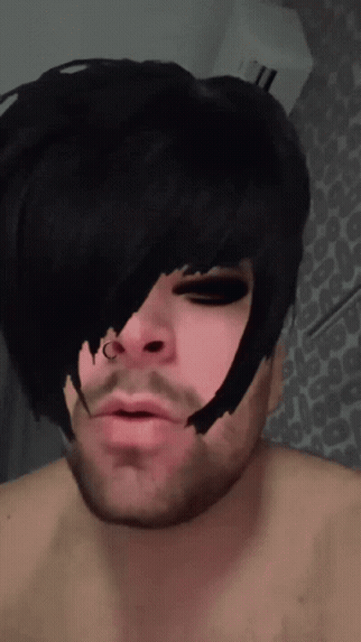 A Man With A Nose Ring Has A Black Haircut GIF