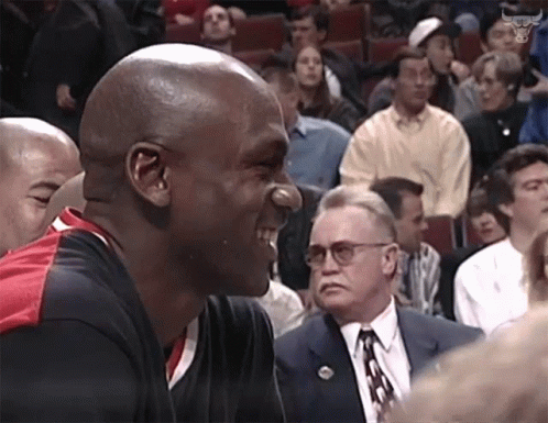 A Man With A Nose Ring Is Laughing In Front Of A Crowd GIF