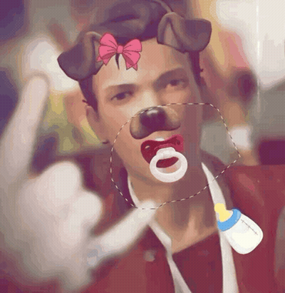 A Man With A Pacifier In His Mouth And A Bottle Around His Neck GIF