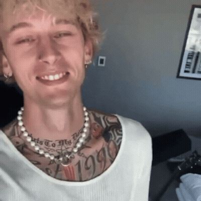 A Man With A Pearl Necklace Around His Neck Has A Tattoo On His Chest That Says " 1995 " GIF