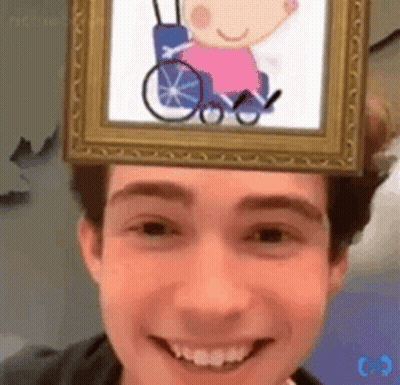 A Man With A Picture Of A Girl In A Wheelchair On His Head GIF