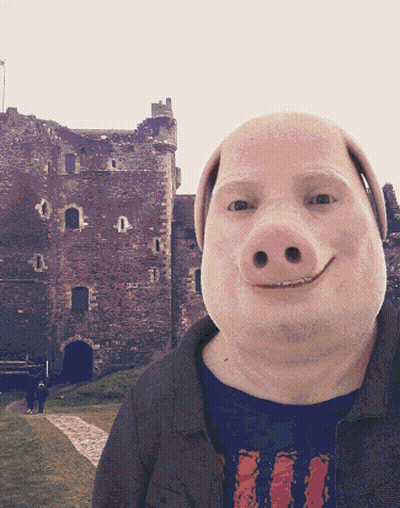 A Man With A Pig 'S Face And A Castle In The Background GIF