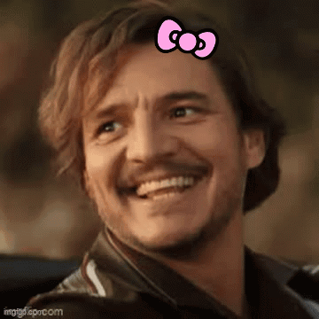 A Man With A Pink Bow On His Head Is Smiling And Looking At The Camera . GIF