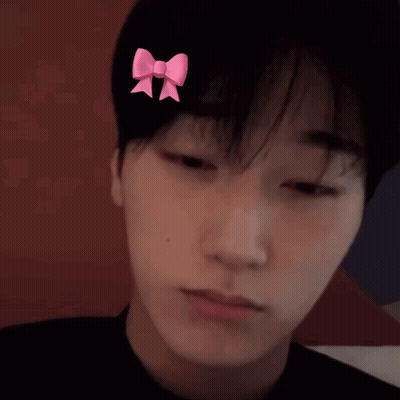 A Man With A Pink Bow On His Head GIF