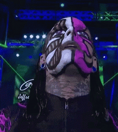 A Man With A Pink Mask On His Face Is Looking At The Camera GIF