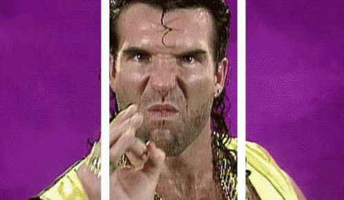 A Man With A Ponytail And A Beard Is Making A Funny Face While Wearing A Yellow Shirt . GIF