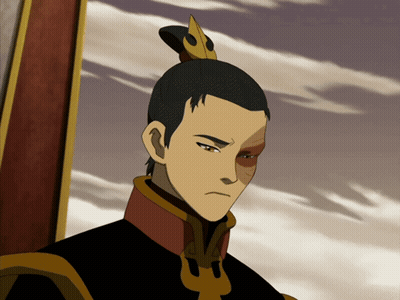 A Man With A Ponytail And A Crown On His Head Looks At The Camera GIF