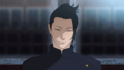 A Man With A Ponytail And A Gold Button On His Jacket GIF