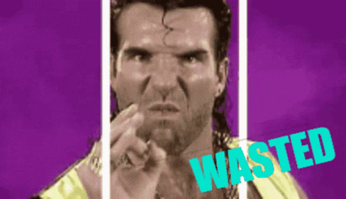 A Man With A Ponytail Is Pointing At The Camera And The Word Wasted Is Visible Behind Him GIF