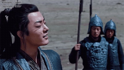 A Man With A Ponytail Is Standing In Front Of A Group Of Soldiers With Their Helmets On GIF