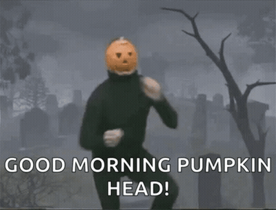 A Man With A Pumpkin Head Is Dancing In A Cemetery GIF
