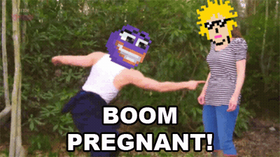 A Man With A Purple Mask Is Pointing At A Woman With The Words Boom Pregnant GIF
