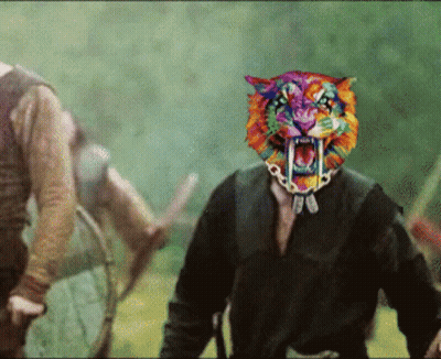 A Man With A Rainbow Colored Tiger Mask On His Head GIF