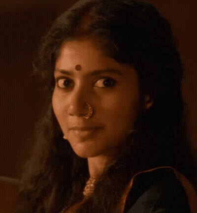 A Man With A Red Circle On His Forehead Looks At The Camera GIF