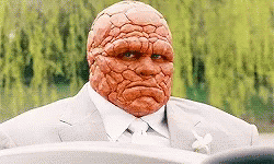 A Man With A Red Face Is Sitting In A Car . GIF