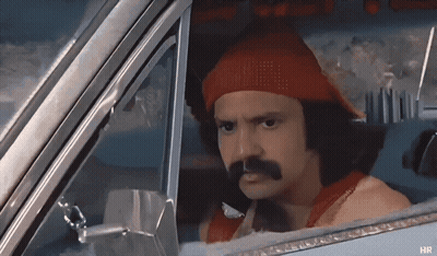 A Man With A Red Hat And Mustache Is In A Car GIF