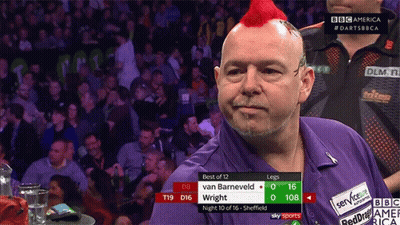 A Man With A Red Mohawk Stands In Front Of A Crowd Watching A Match Between Van Barneveld And Wright GIF