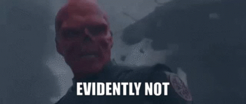 A Man With A Red Skull On His Face Is Standing In Front Of A Building With The Words Evidently Not Written On It . GIF