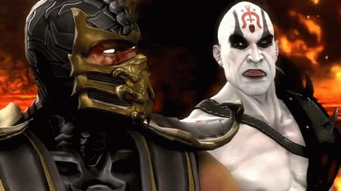 A Man With A Red Symbol On His Forehead Is Standing Next To A Man With A Mask On GIF