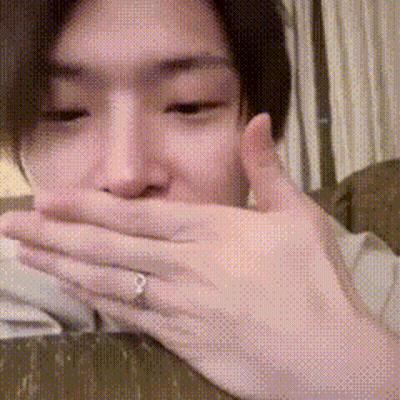A Man With A Ring On His Finger Covering His Mouth GIF