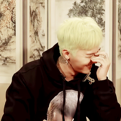 A Man With A Ring On His Finger Is Covering His Nose With His Hand GIF