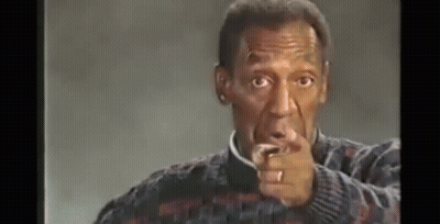 A Man With A Ring On His Finger Is Pointing At The Camera . GIF