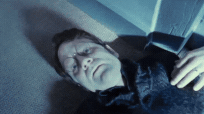 A Man With A Ring On His Finger Laying On The Floor GIF