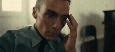 A Man With A Ring On His Finger Looks At Something GIF